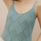 Woman wearing blue crochet tank top.