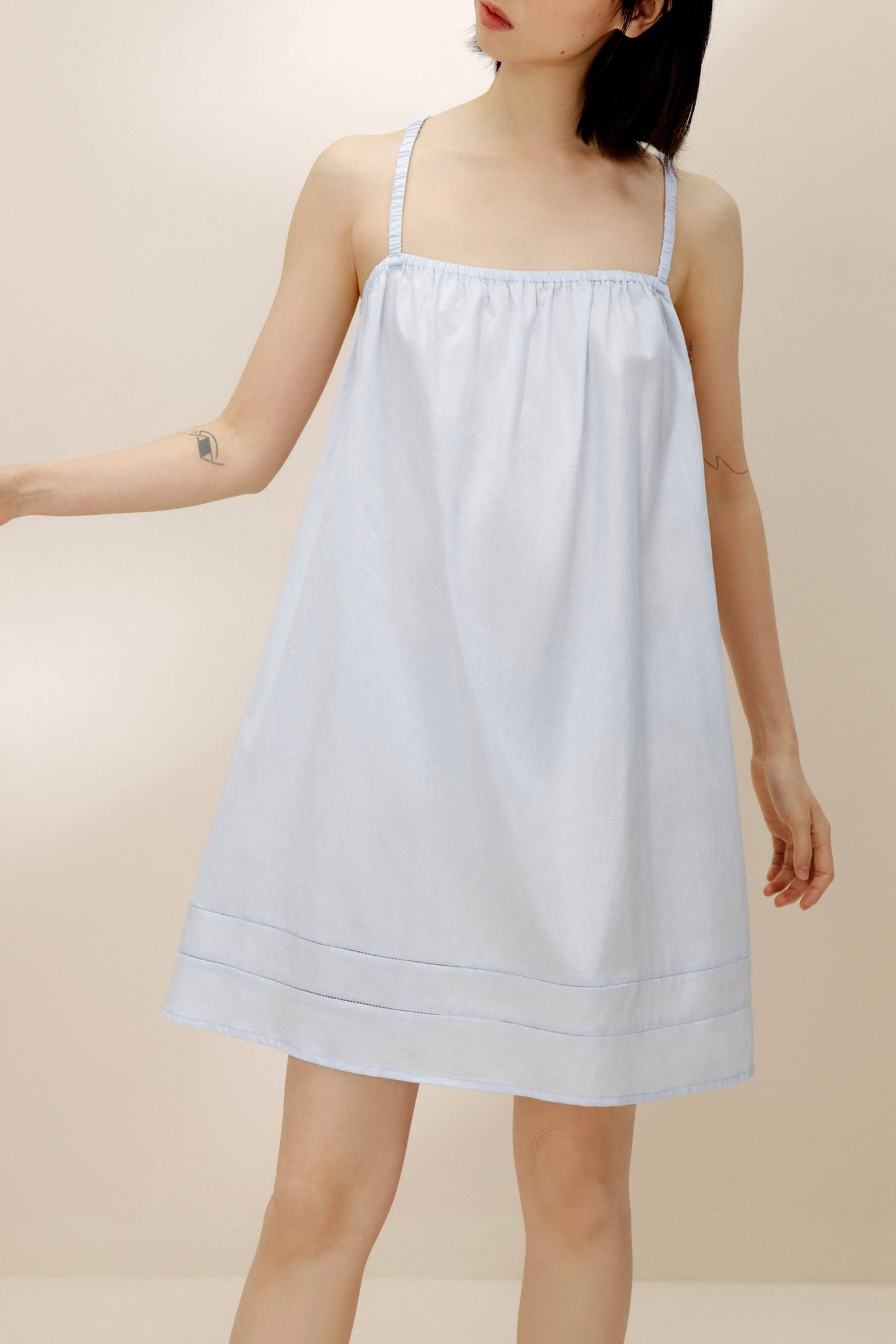 Woman wearing light blue pajama dress