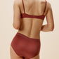 back of woman in maroon bra and brief