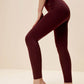 woman standing side way wearing dark red leggings