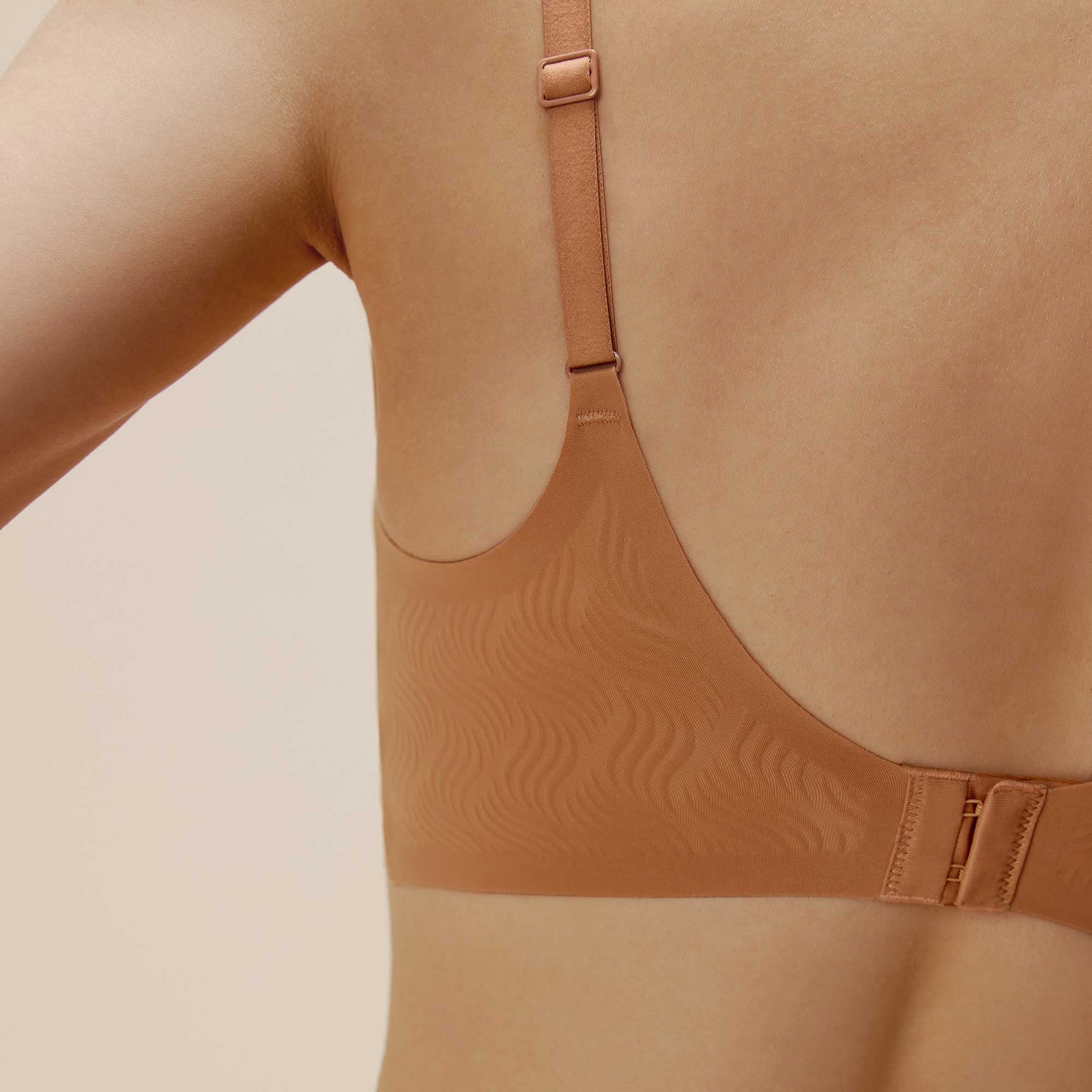 Brown shapewear garment on a beige background