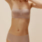 Woman wearing blush-colored strapless bra and underwear set