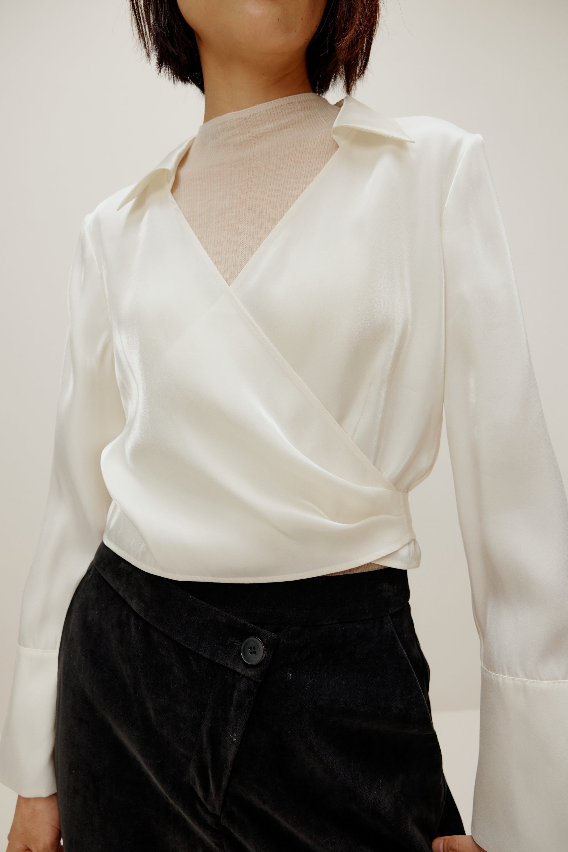 woman in white satin shirt and black bottoms