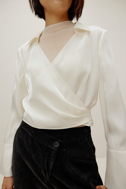 woman in white satin shirt and black bottoms