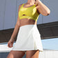 woman in yellow sports bra and white tennis skort