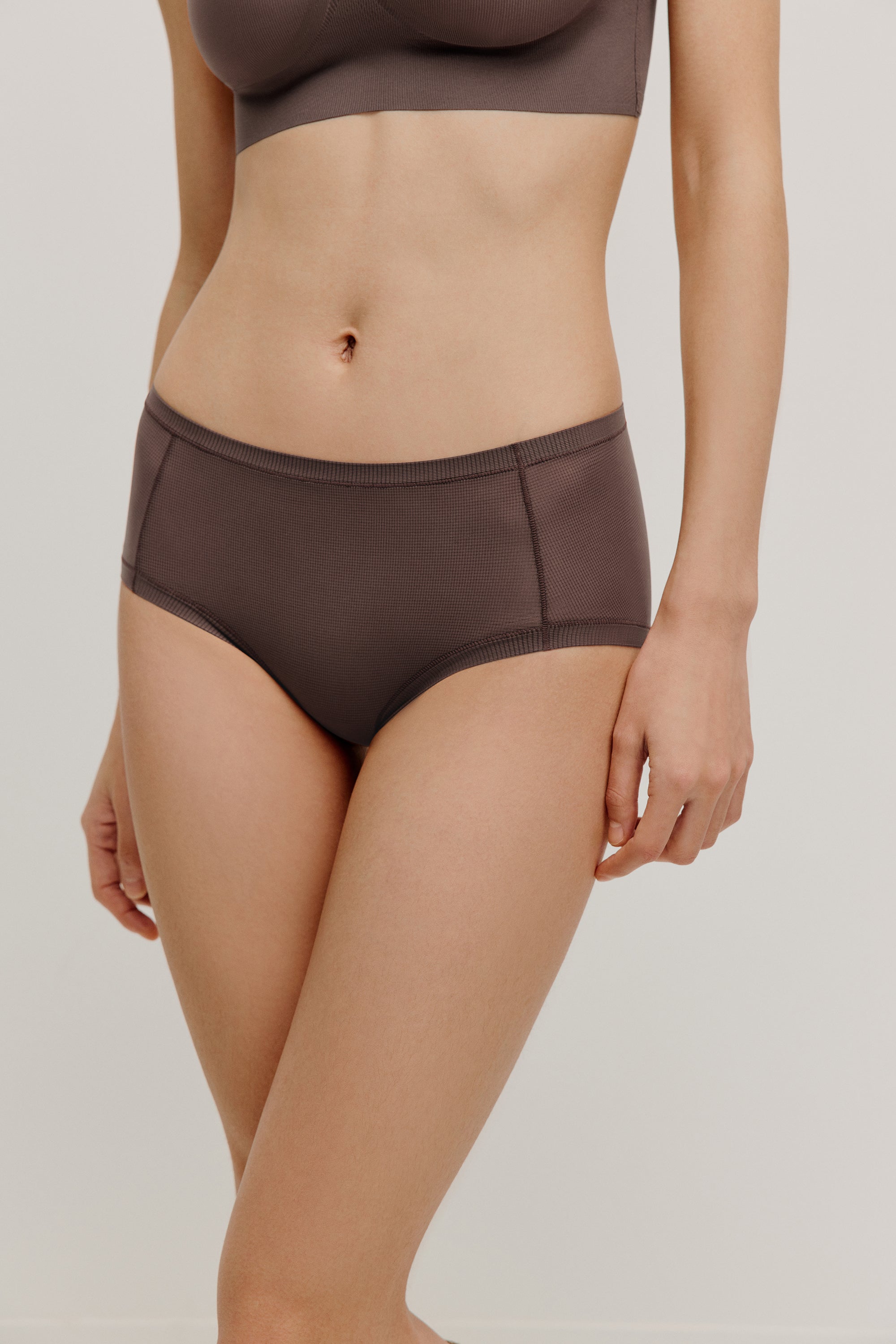 woman in dark purple color brief
