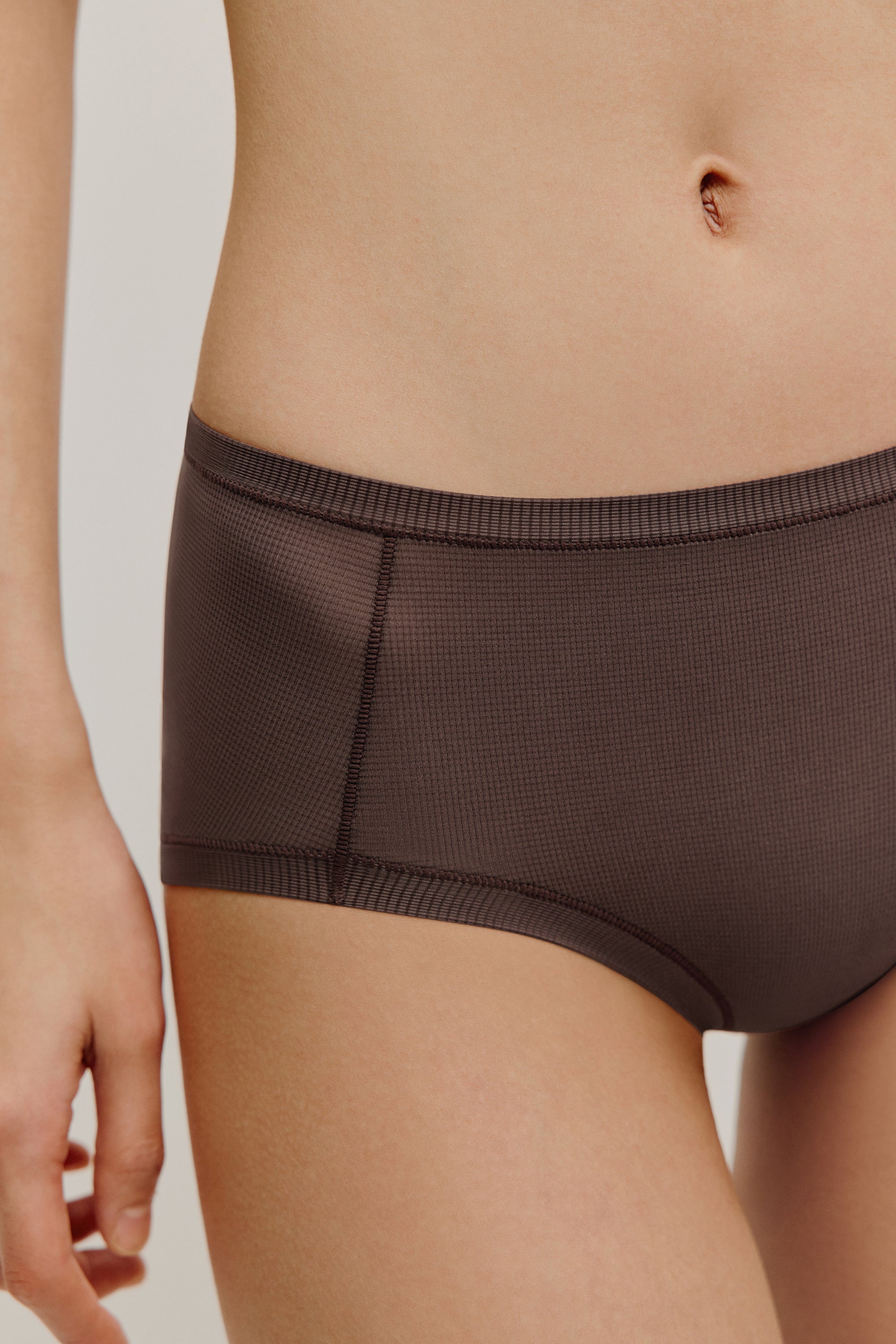 woman in dark purple brief