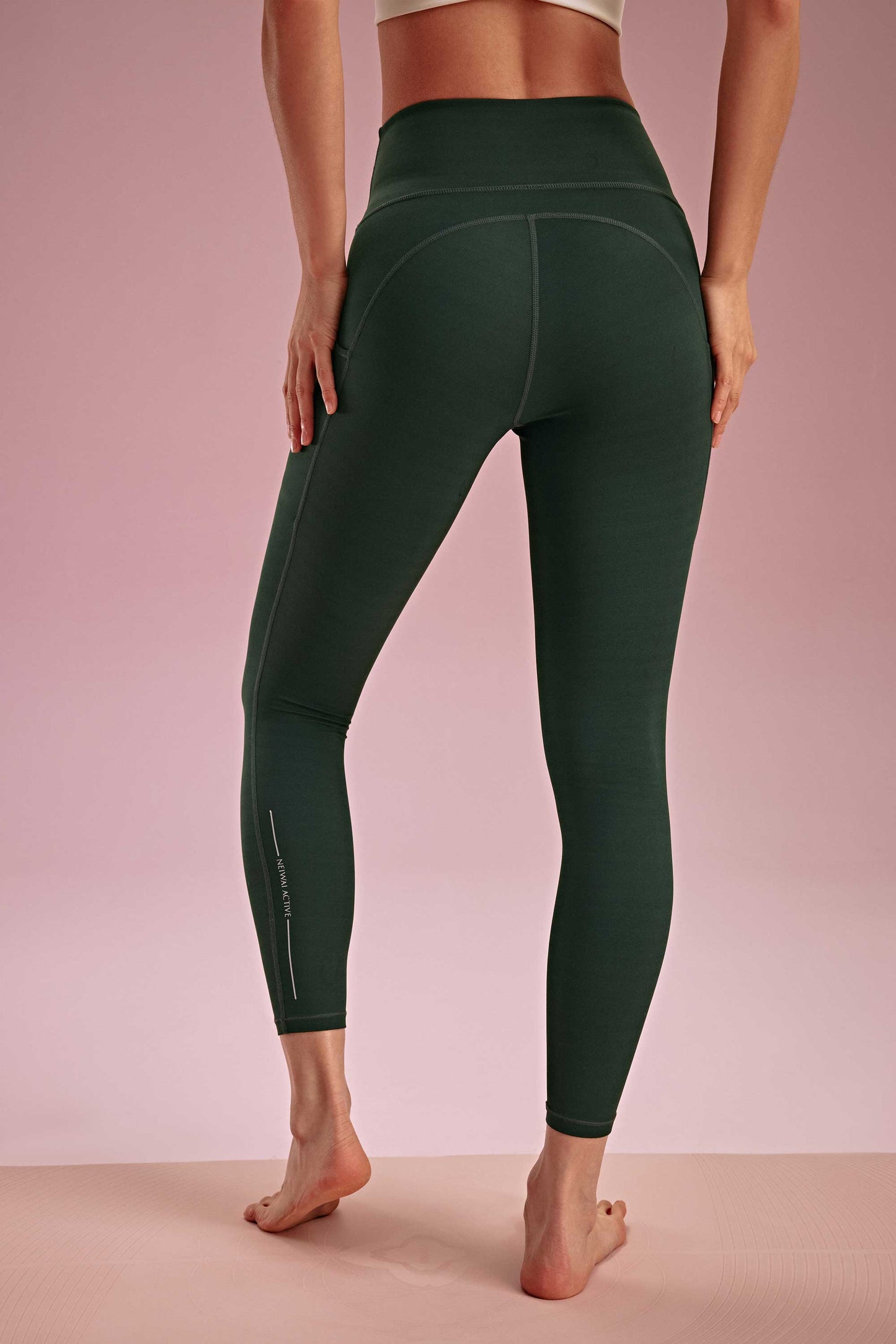 back of a woman wearing a green leggings