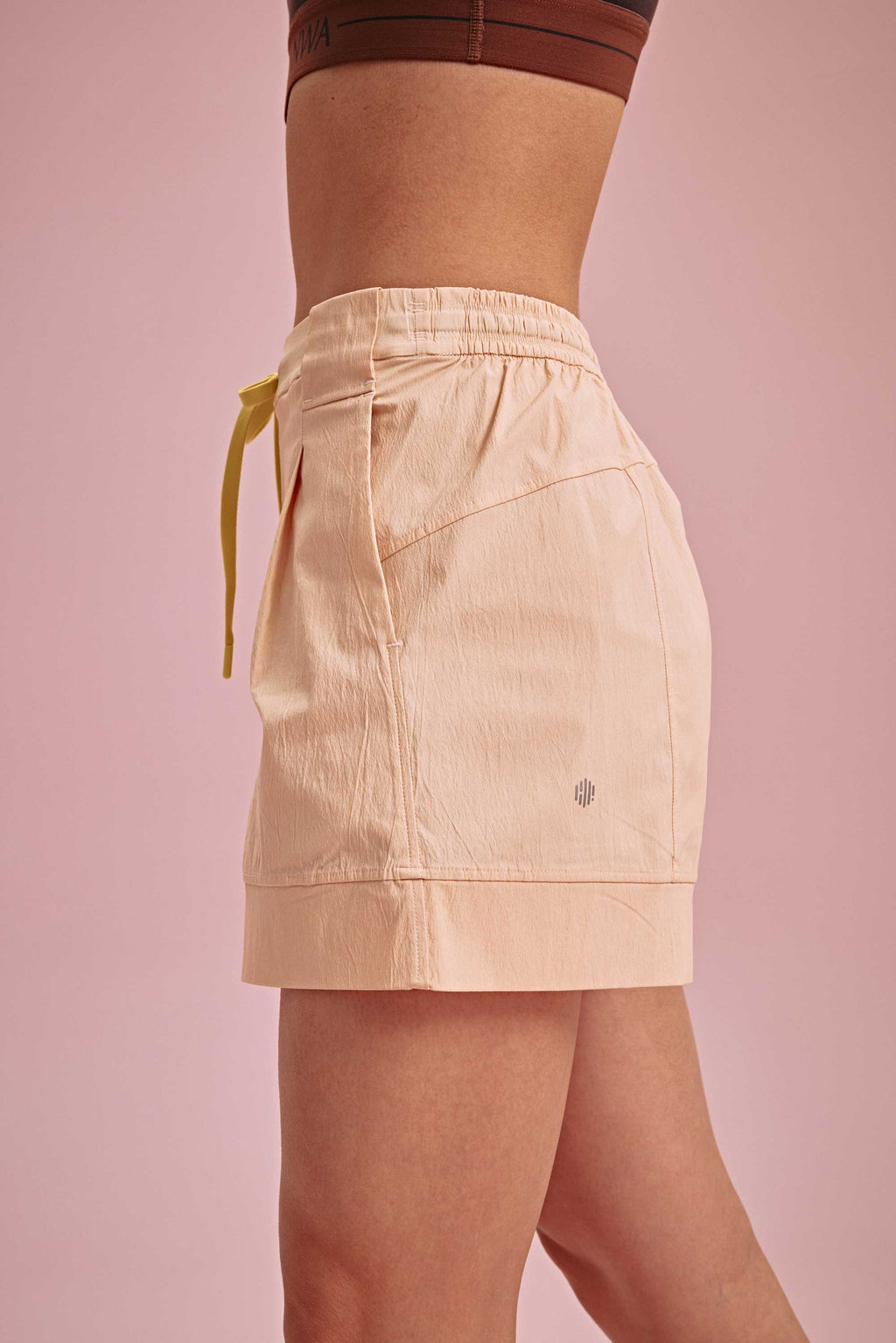 side of the warm yellow shorts with yellow knot and neiwai active logo
