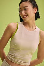 a woman wearing a cream tank