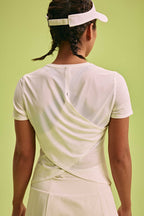 back of a woman wearing white Cross-back T-Shirt and a hat 