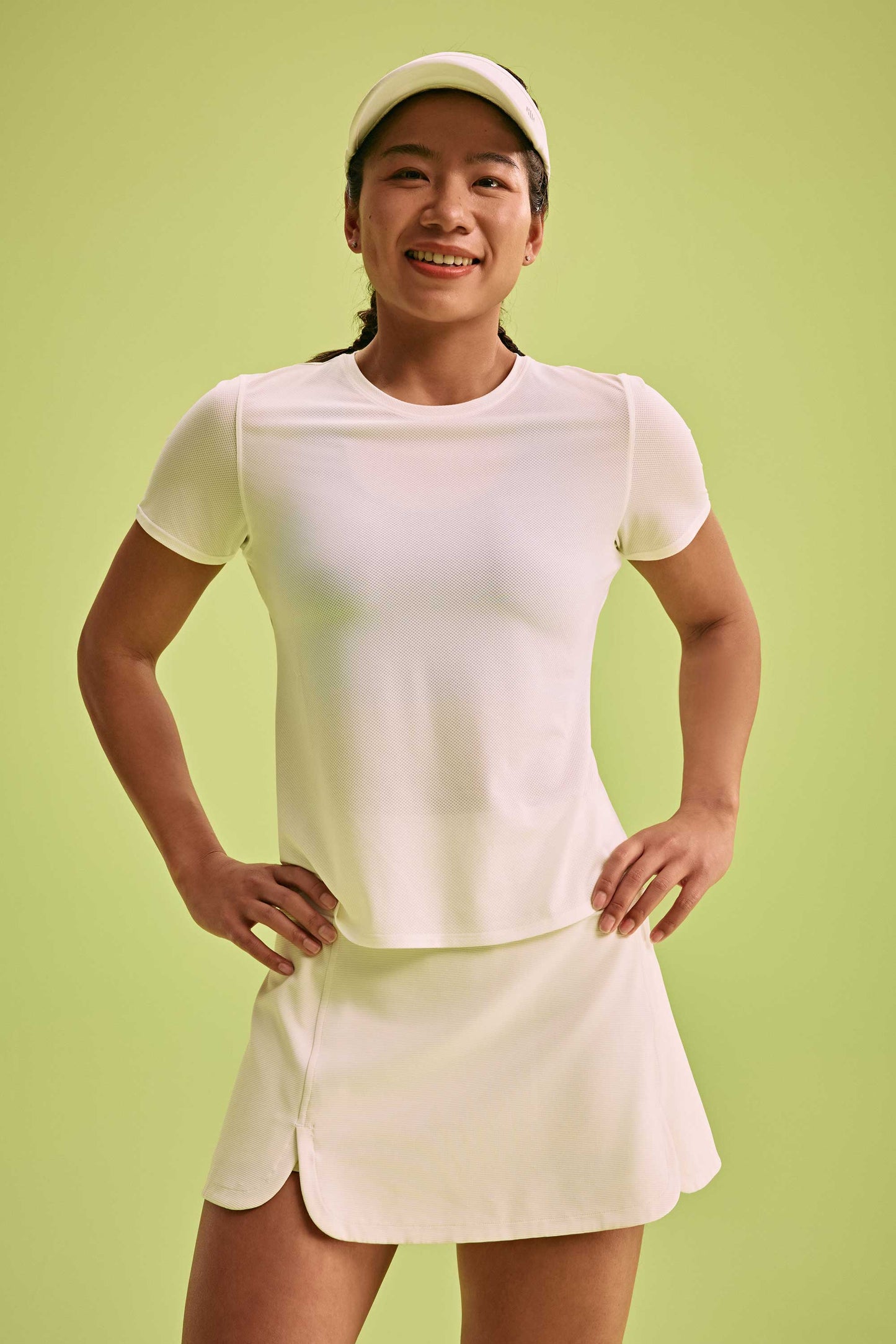 a woman wearing white top and white skirt and a white hat 