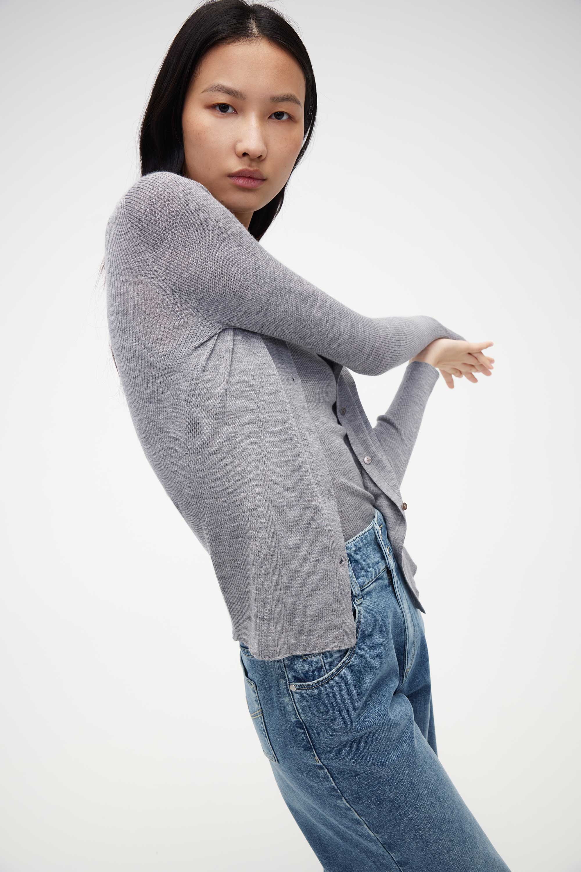 woman in grey cardigan