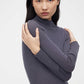woman in purple mock neck sweater