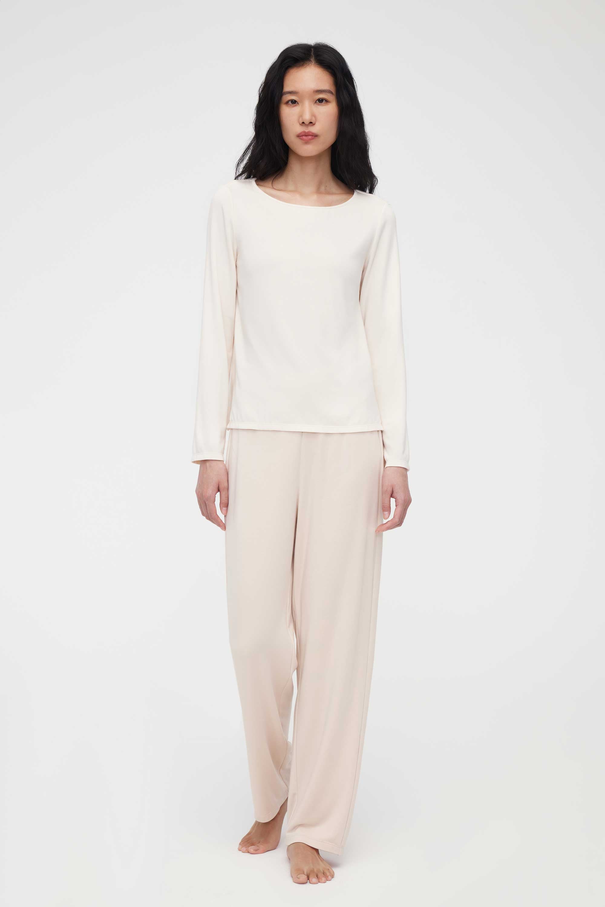 A woman wearing a cream pajama set