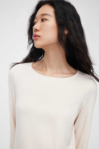 close up of woman in cream pajama t-shirt