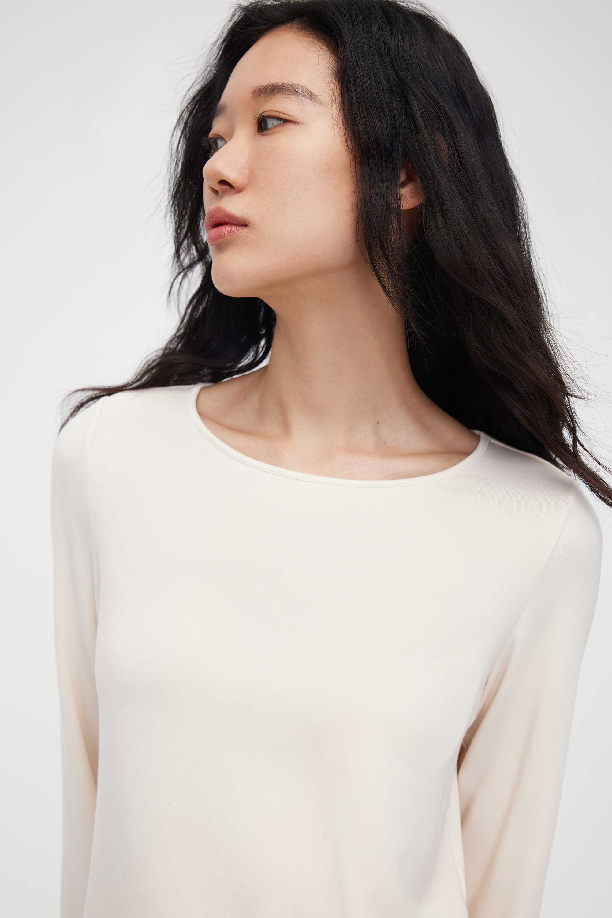 close up of woman in cream pajama t-shirt