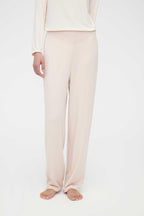 A woman wears a cream pajama set