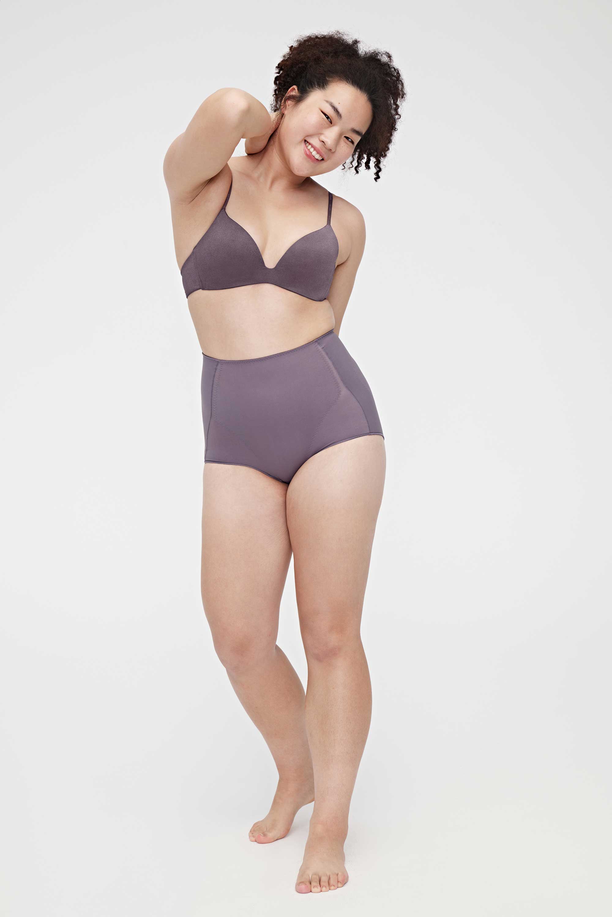A woman wearing a purple triangle bra and purple panties