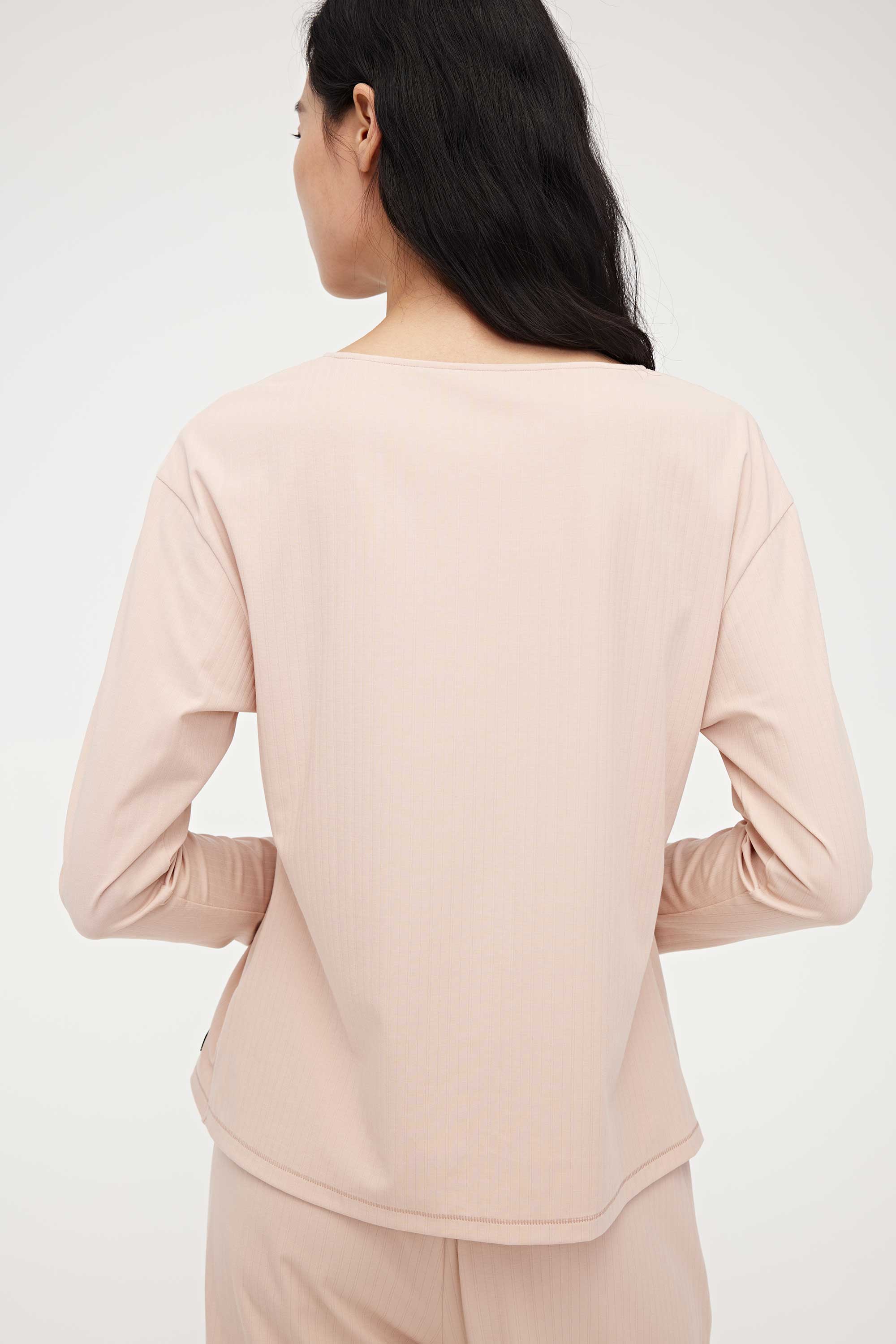 back of woman in pink lounge t-shirt and pants