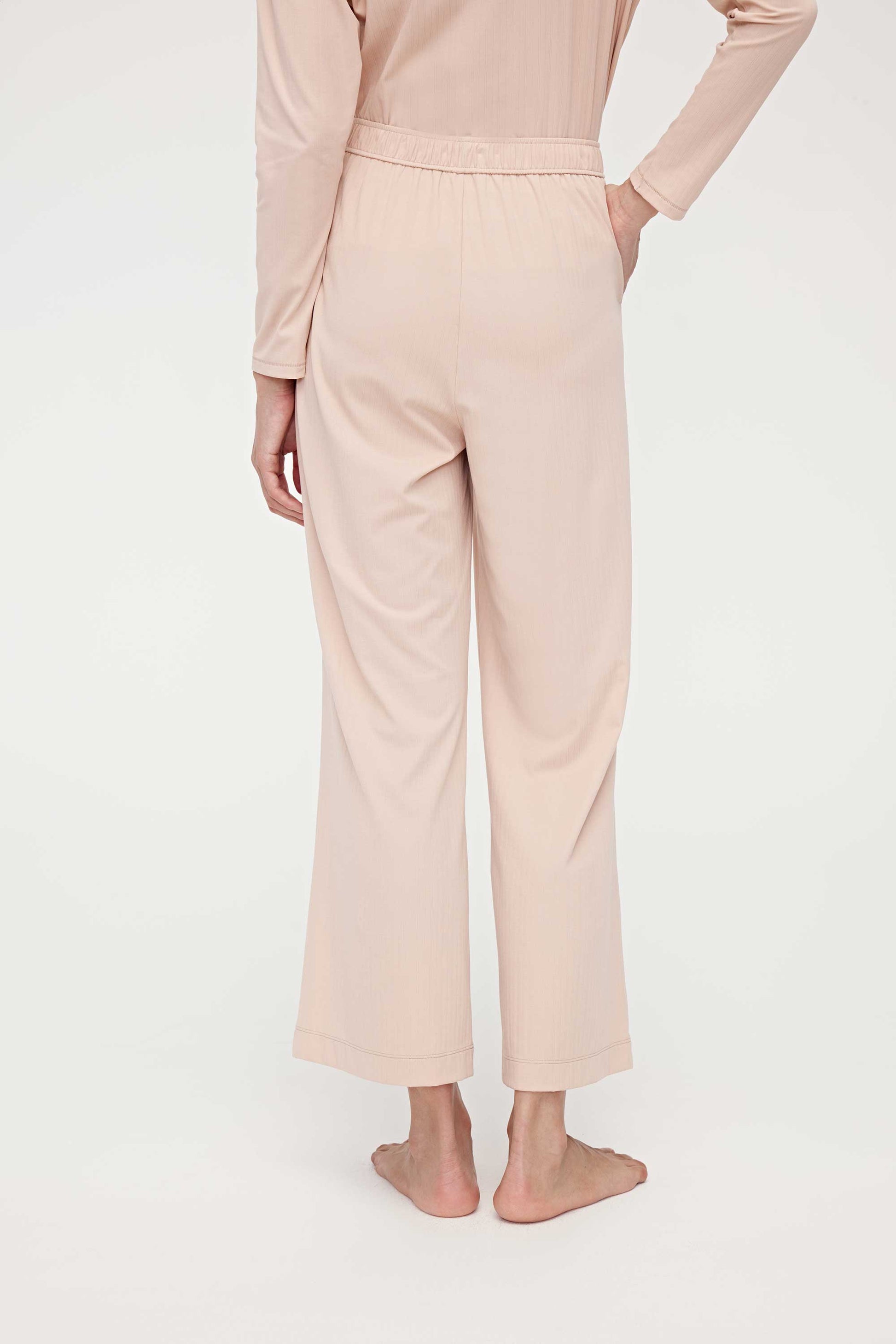 back of woman in pink lounge pants