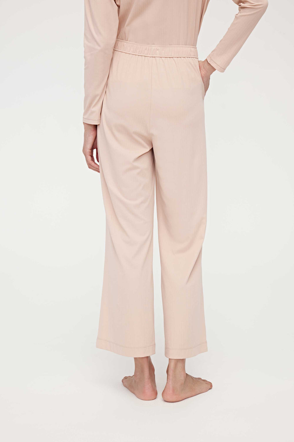 back of woman in pink lounge pants