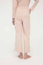 back of woman in pink lounge pants
