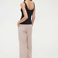the back of woman in black tank top and pink lounge pants