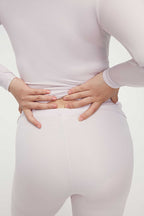 back of woman in light pink thermal wear set