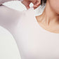 close up of woman in light pink thermal top