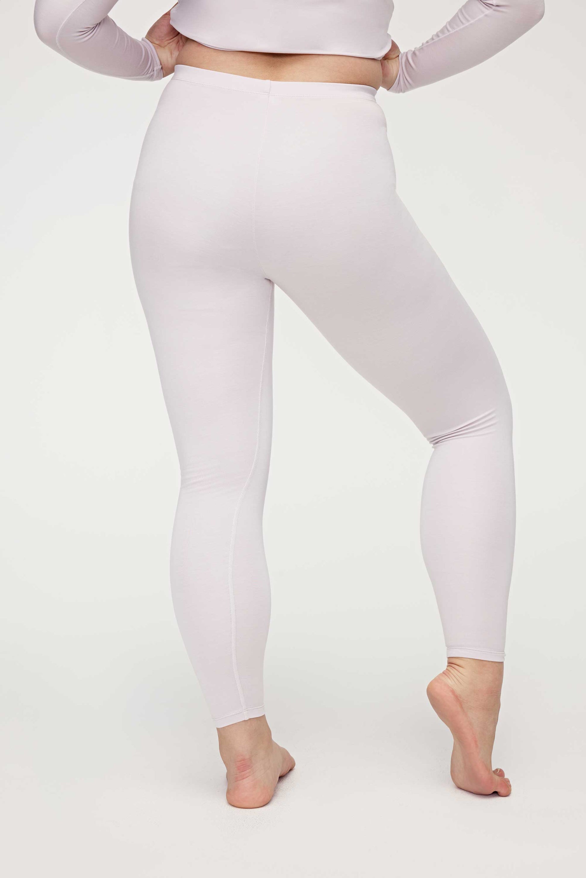 back of woman in light pink thermal pants