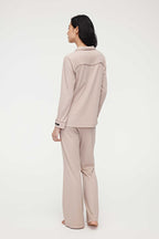 back of woman in coffee button up pajama set