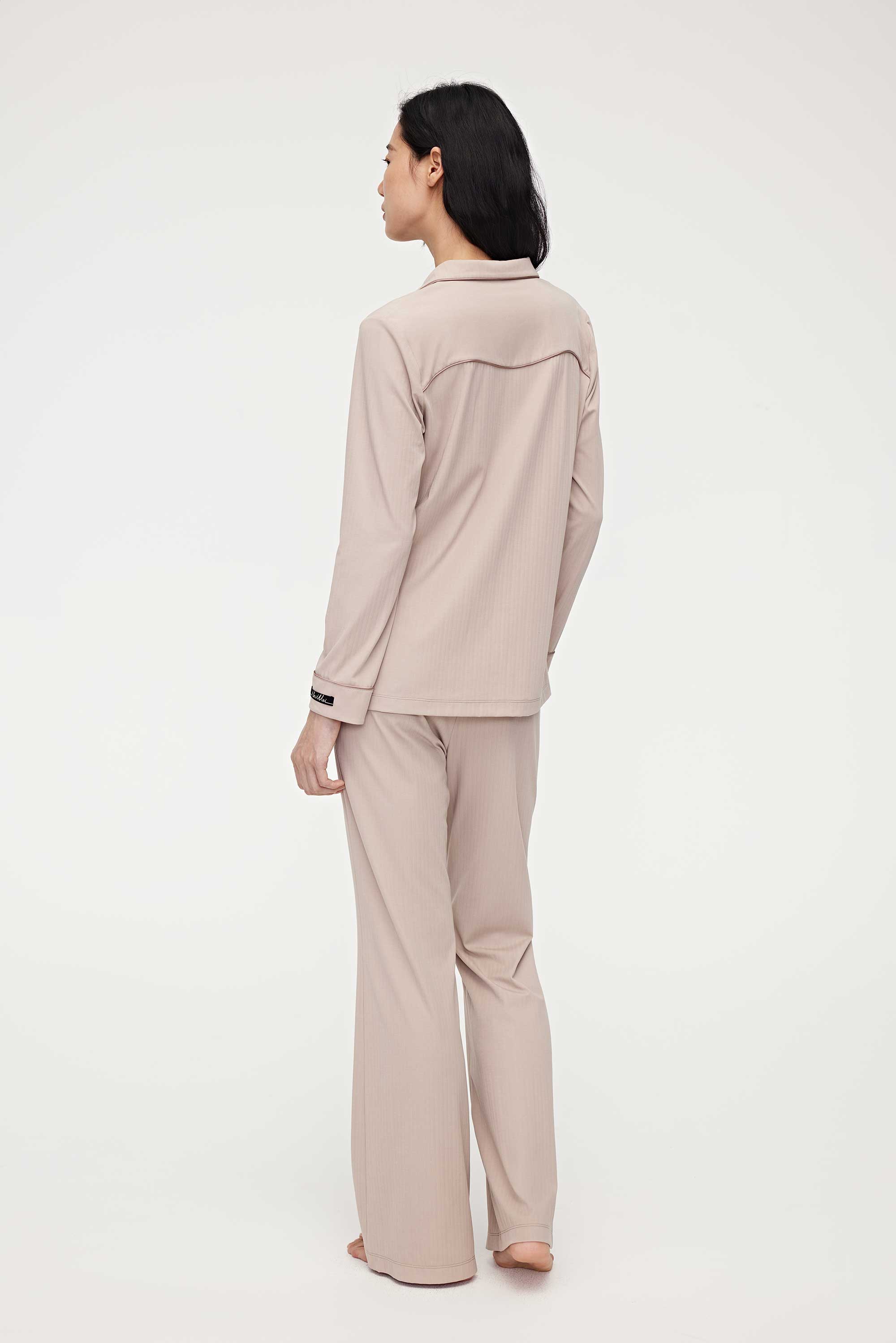 back of woman in coffee button up pajama set