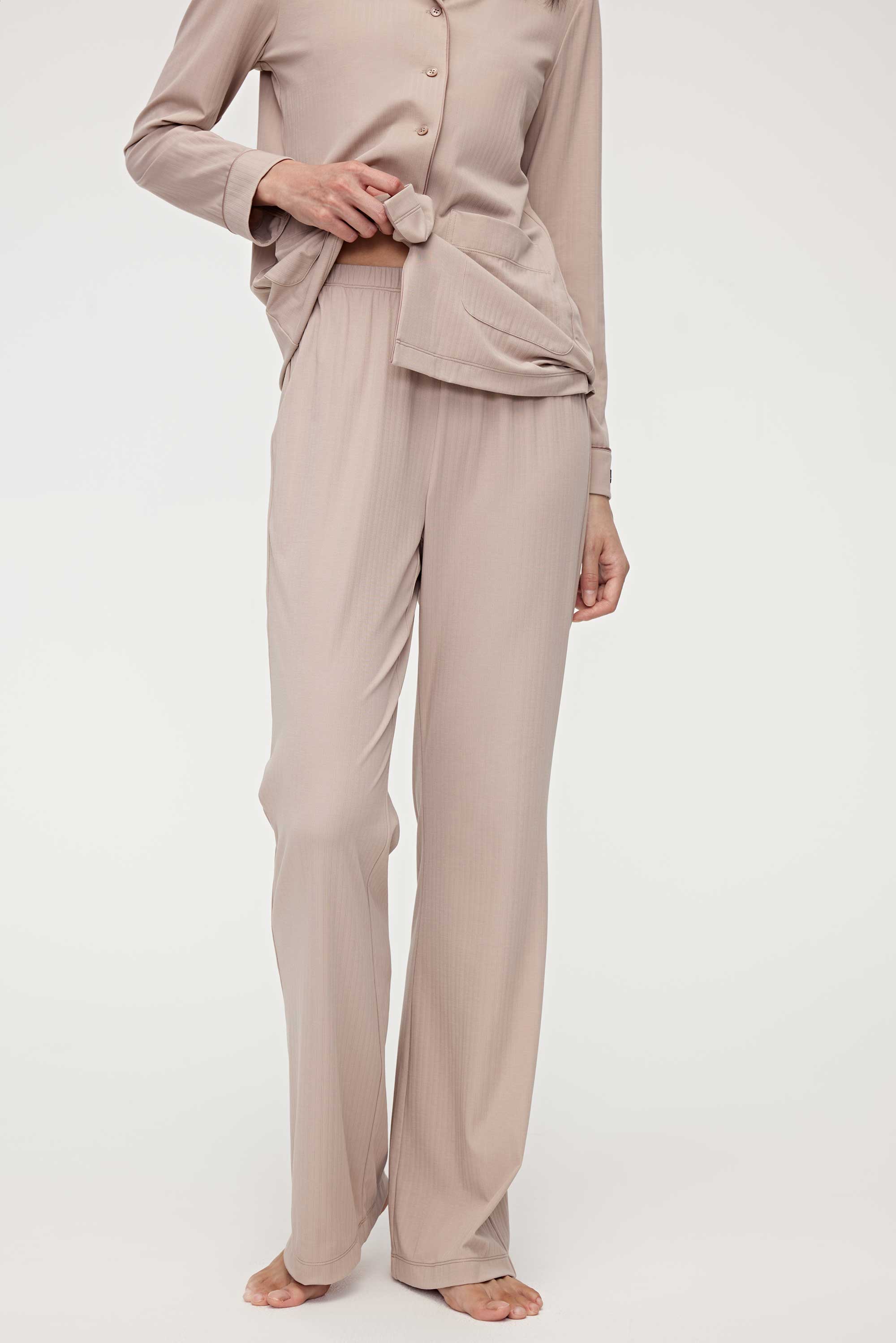 woman in coffee button up pajama set