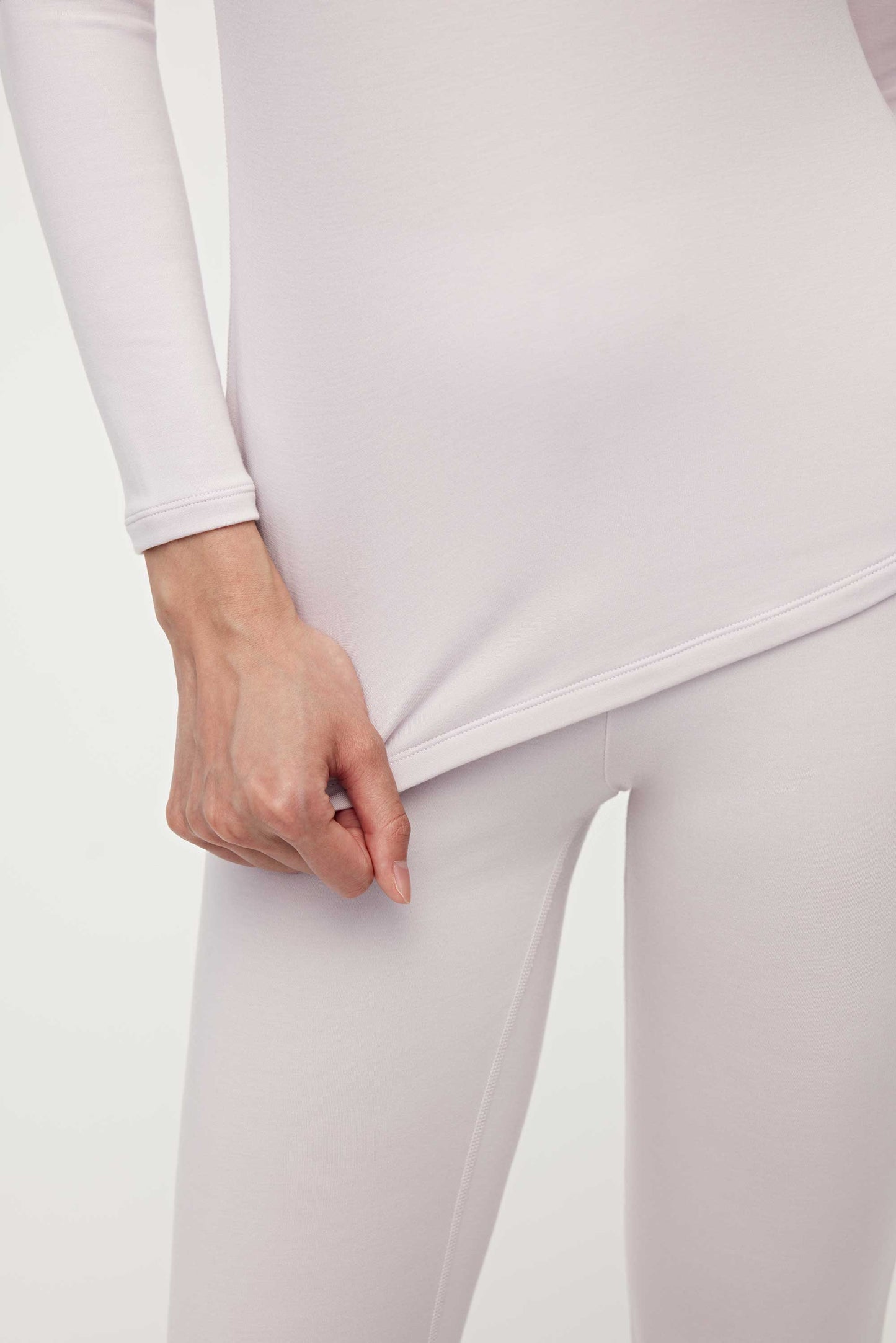 close up of woman in light pink thermal wear set