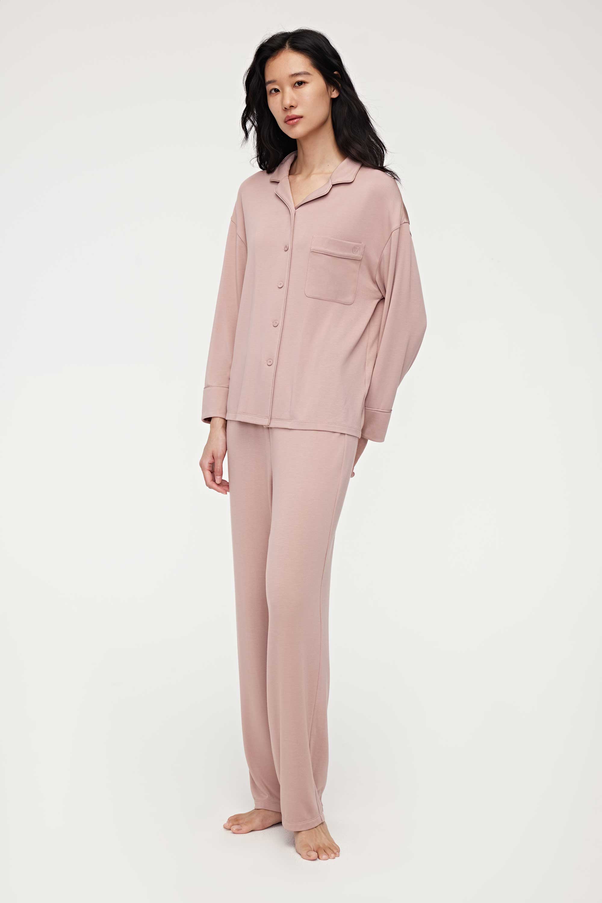A woman wearing a pink pajama set