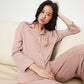A woman wearing a pink pajama set