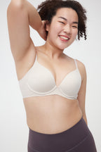 Woman wearing cream bra and a purple pants