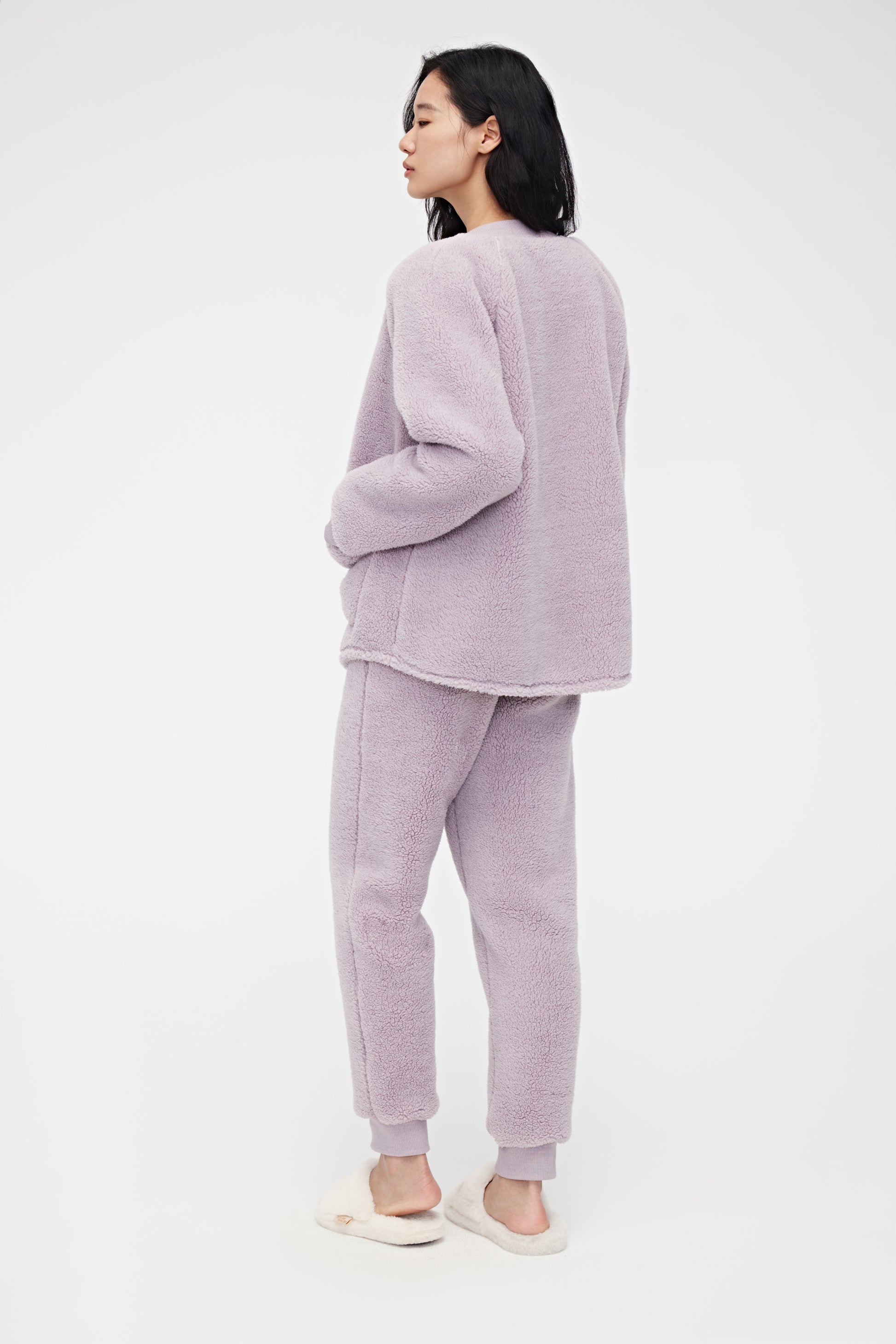 Back view of woman wearing purple Fleece Pajama Set