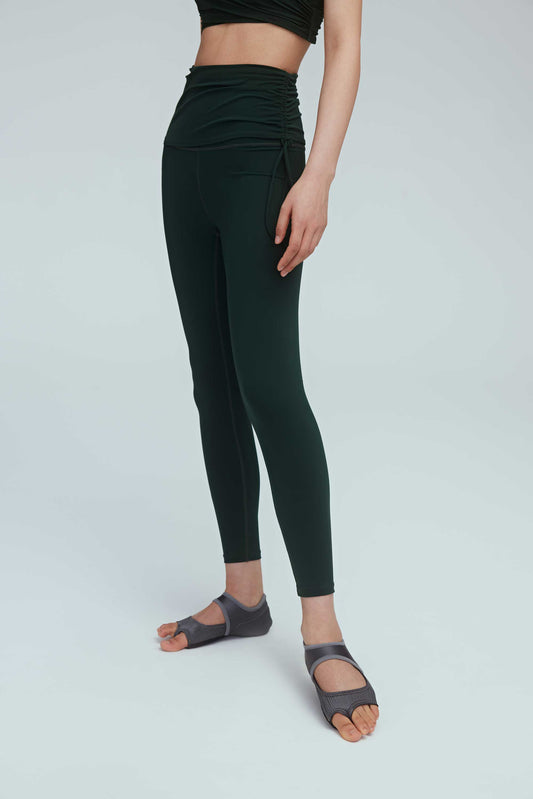 a woman wearing a green drawstring leggings 