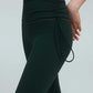 side of a woman wearing a green drawstring leggings