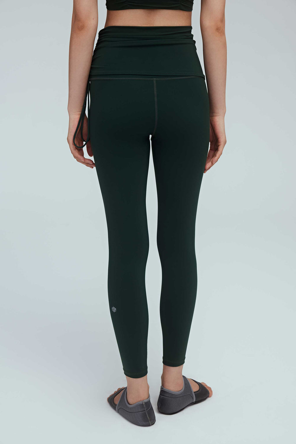 back of a woman wearing a green drawstring leggings