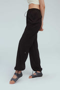 a woman wearing a brown joggers