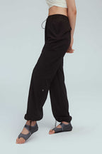 a woman wearing a brown joggers