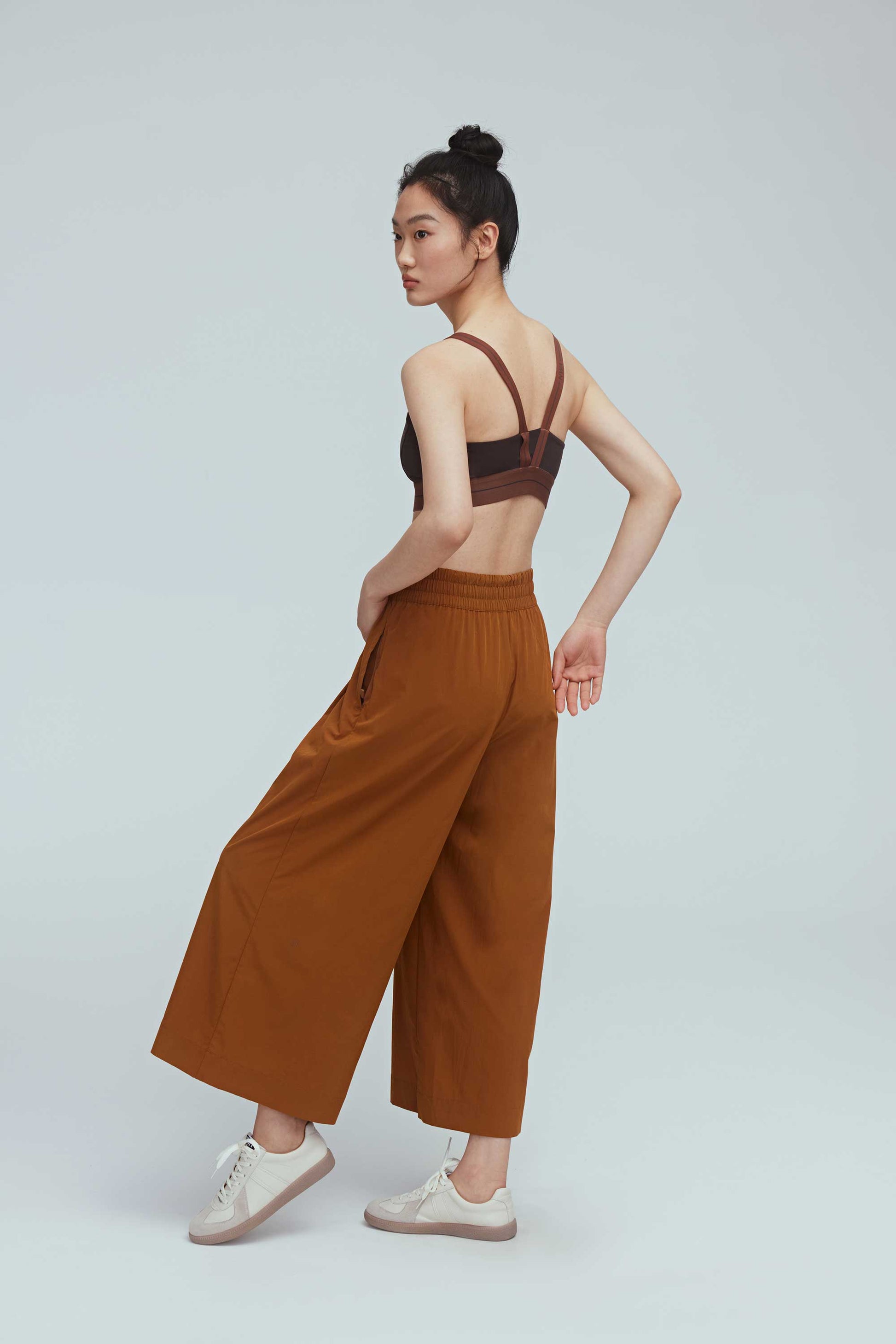 back side of woman in brown culottes
