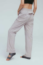 back of a woman wearing grey joggers