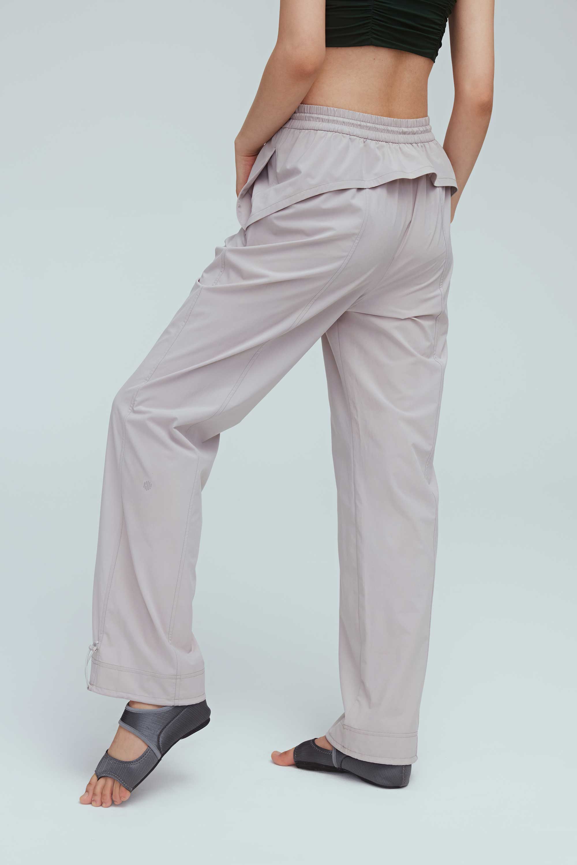 back of a woman wearing grey joggers