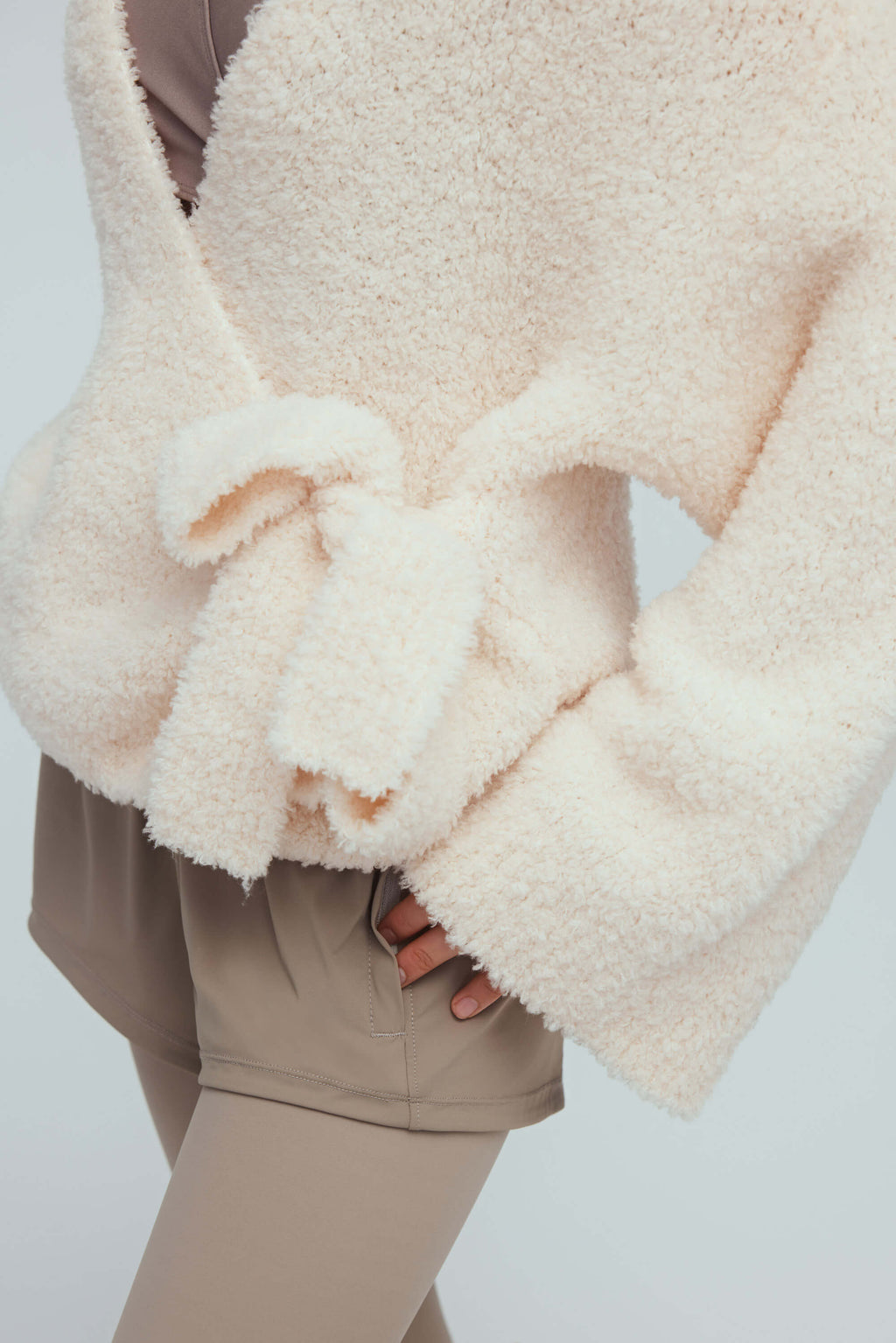 detail shot of white wool cardigan knot