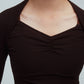 closeup shot of a woman wearing a brown ballet wool shirt