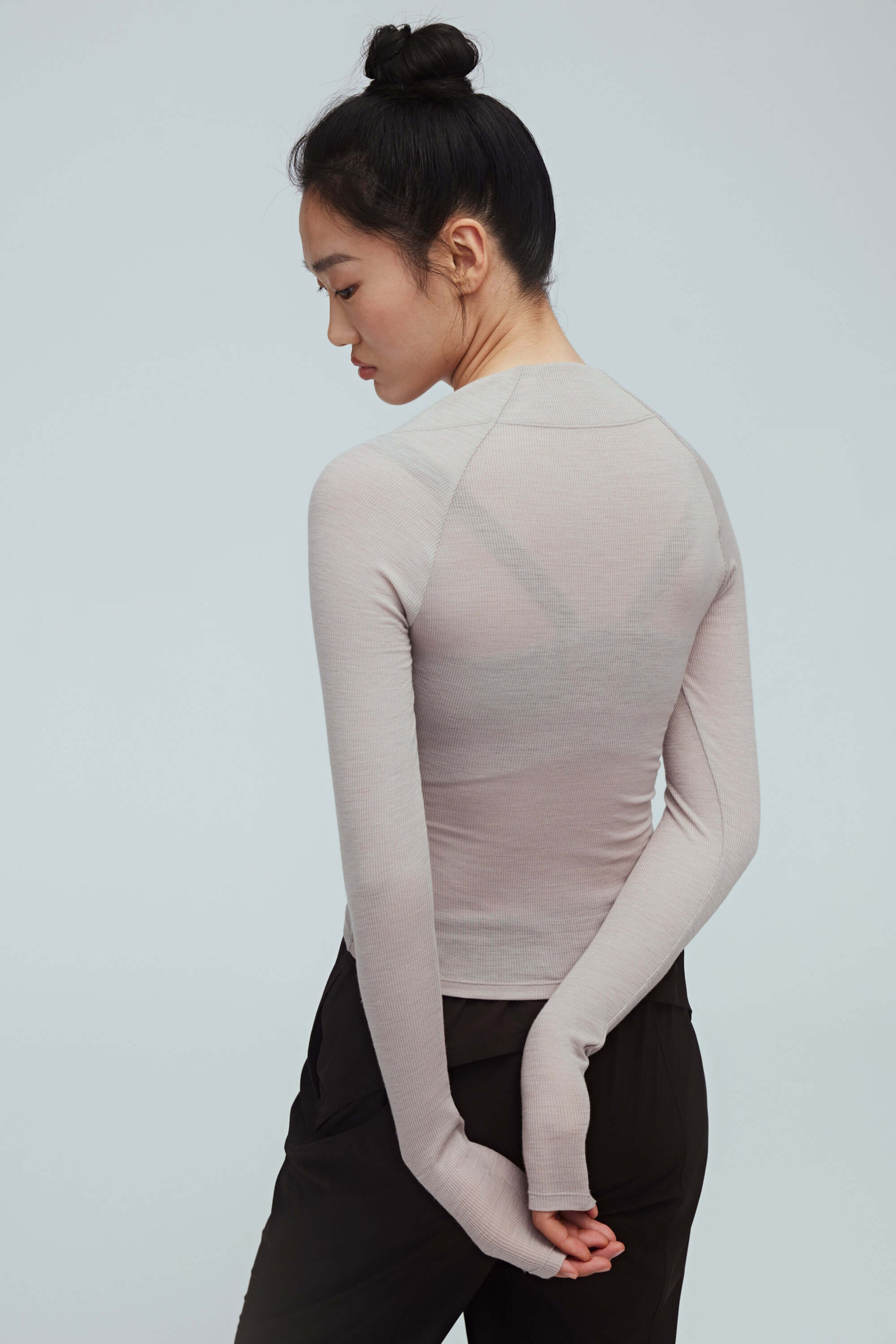 back of a woman wearing a light grey ballet wool shirt